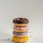Food Aesthetics - Stack of colorful doughnuts topped with sprinkle #11188680