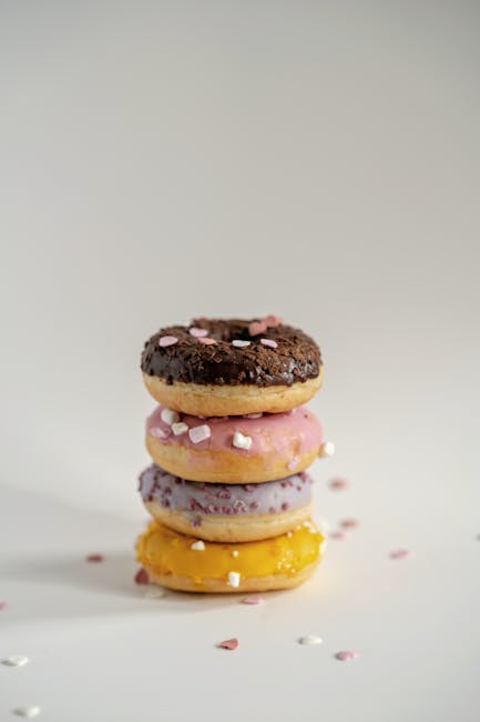 Food Aesthetics - Stack of colorful doughnuts topped with sprinkle #11188680