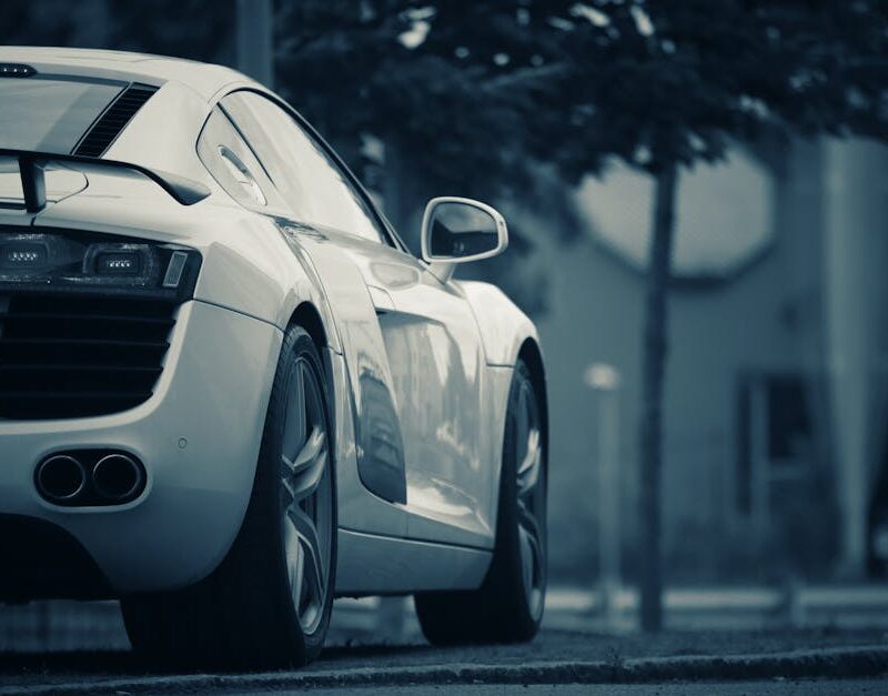 Luxury Cars - A luxury white sports car parked on a street in #13148546