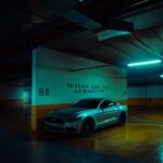 Luxury Cars - A Ford Mustang parked in a dimly lit garage with #13693478