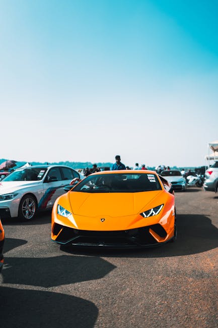 Luxury Cars - An orange Lamborghini stands out at an outdoor c #14843593