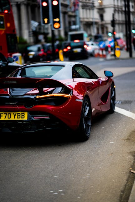 Luxury Cars - A sleek red supercar parked on a bustling street #6152807