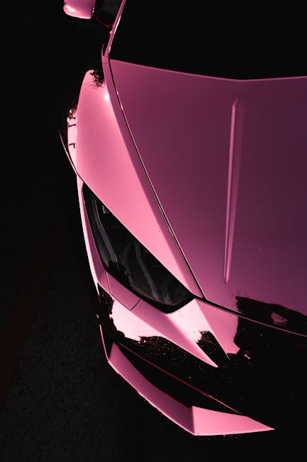 Luxury Cars - Close-up of a shiny pink luxury sports car highl #6891804