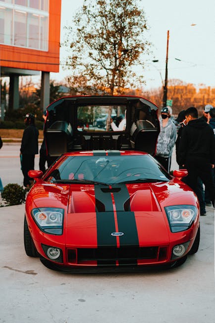 Luxury Cars - A striking red Ford GT with black stripes displa #6891810