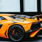 Luxury Cars - Close-up of an orange Lamborghini Aventador park #9322194